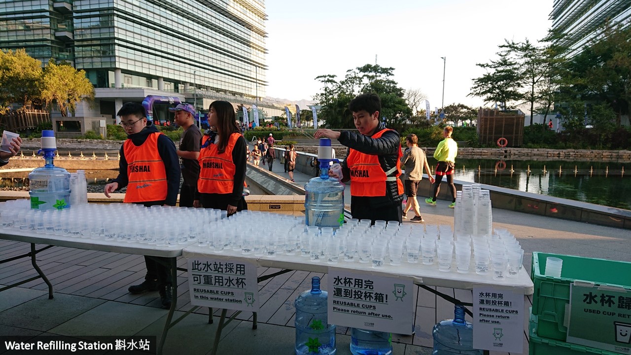 Water refilling station at a running event and reusable cups are provided for participants usage