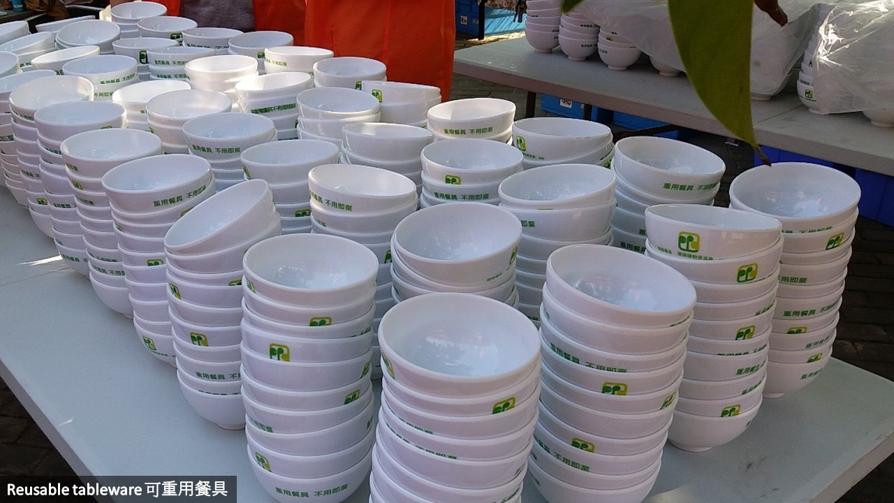 Many reusable plastic bowls are neatly placed on a table